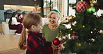 Christmas tree, decoration and happy old woman with grandchild in living room of home together. Bonding, festive celebration or smile with girl and grandmother in apartment for December holidays