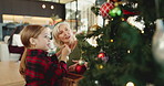 Christmas tree, decoration and senior woman with grandchild in living room of home together. Activity, bonding or festive celebration with girl and grandmother in apartment for December holidays