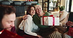 Happy family, hug or mature mom with gift for Christmas, support or festive celebration. Care, smile or woman giving xmas present for gratitude, senior parent or love for holiday tradition in home