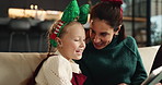 Christmas, mother and child laughing with tablet on sofa for festive meme, joke or family talking. Xmas, happy kid and mom with tech in home for funny game, story and bonding on holiday with parent