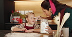 Christmas, baking and playing with child and mother together with flour and fun. Bonding, tradition and family home to teach kid to bake homemade treats and celebrate a holiday with messy game