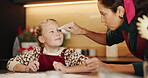 Christmas, baking and flour on forehead with child and mother together for fun game. Bonding, tradition and family home to teach kid to bake homemade treats and celebrate a holiday while playing