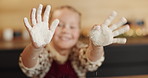 Hands, flour and girl in kitchen, kid and baking with fun, learning and ingredients. Face, happy and child development with recipe, food and cooking with delicious pastry, showing palms and home