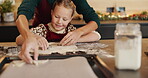 Christmas, baking and cookie cutter with child and mother together for learning and help. Bonding, tradition and family home to teach kid to bake homemade xmas treats to celebrate a christian holiday