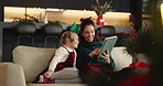Christmas, mother and kid with tablet in home for festive movie, learning and scroll online store. Xmas, girl and happy parent with tech on sofa for holiday film, decoration ideas and gift shopping