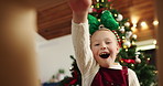 Happy girl, christmas or surprise with gift box below for holiday present or festive giving in home. Excited, child or kid opening package with smile, wow or thank you for santa weekend in house