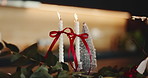 Candle, Christmas tree and festive decoration for December, vacation season and living room in home. Closeup, flame ornament and decor for celebration with event, holiday or weekend with background