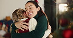 Christmas, hug and smile of mother with daughter in living room of home for festive celebration. December, love or winter with girl child and single parent woman embracing in apartment for holidays