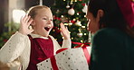 Surprise, girl and mother with gift, Christmas and tradition with holiday season, home and excited. Family, parent and mama with daughter, shock and present with Xmas celebration and bonding together