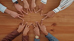 Business people, hands and star with unity above for collaboration, team building or mission. Top view, group or employees with fingers in solidarity for connection, union or synergy on wooden table