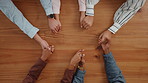 Group, business and people holding hands on table for partnership, teamwork and success. Above, collaboration and motivation with employees synergy, celebration and solidarity for company achievement