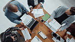 Above, documents and business people in meeting, graphs and accounting with feedback for budget report. Group, employees or financial advisor in office, negotiation and collaboration for investment