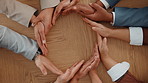 Business people, hands and link in circle for collaboration, teamwork or synergy at table. Above, group or together in office with gesture, solidarity or workforce integration for company cooperation