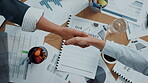 Meeting, colleagues and handshake for merger, paperwork and team with deal for project or agreement. Above, people or shaking hands for collaboration in boardroom, documents and success of investment