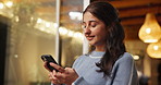 Phone, smile and woman in home at night for text, romantic message and internet notification. Mobile, person and communication for social media, chat and download app for online dating with bokeh