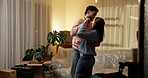 Moving in, night and couple with dancing in new house for property investment, relocation or goals. Evening, people and celebration in first home for mortgage security, freedom or real estate success