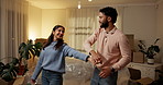 Spinning, happy and couple with dancing in new house for investment success, freedom and night. Evening, people and celebration in first home for mortgage security, moving in and real estate purchase