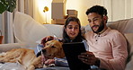 Couple, dog and tablet in new home to search for renovation idea, inspiration or moving service review. Man, woman and pet on sofa with technology for planning, relocation and mortgage payment plan