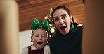 Happy mom, daughter and christmas with gift box or surprise below for holiday present in home. Excited, mother or kid opening package with smile, wow or thank you for santa weekend or giving in house