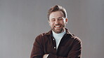 Face, business man and arms crossed in studio with smile, graphic designer and confidence. Person, portrait and entrepreneur for creative startup, agency or happy for project pride on gray background
