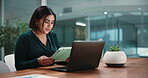 Business, woman and reading on tablet in office for research, finance report and auditing. Person, laptop and graph comparison of financial growth, review budget and information of investment company