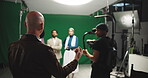 Conversation, film and media with director on set for advertising, production or videography. Behind the scenes, direction and green screen with man speaking to talent in studio for instructions