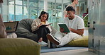 Students, tablet and discussion with book, education and problem solving for test at study lounge. People, tech and help with learning notes, solution and happy with writing info for university exam