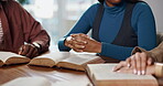 Prayer, group and hands with scripture, bible study or explanation of verse for religion or worship. Reading, literature or people with book for guidance, together or Christian with gospel for belief