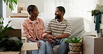 Conversation, holding hands and black couple on sofa in new home with love, bonding and care. Happy, connection and African man with woman in living room for moving with cardboard boxes in apartment.