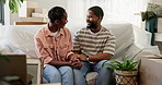 Conversation, happy and black couple on sofa in new home with love, bonding and holding hands. Care, connection and African man with woman in living room for moving with cardboard boxes in apartment.