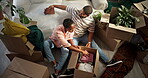 Moving in, couple and unpacking boxes in new home for relocation, property purchase and teamwork. Support, black people and help with unboxing clothes in first house with real estate success or above
