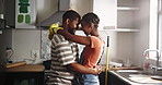 Black couple, dance and love in kitchen for home renovation, upgrade and bonding. New house, paint supplies and people happy for makeover with fun, support and care with teamwork for smile and diy