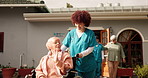 Woman, nurse and wheelchair with senior patient in retirement home for assisted living or help. Female people, caregiver and walking elderly person with a disability for healthcare at old age center