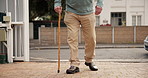 Outdoor, walking stick and old man with retirement, legs and movement with wellness. Closeup, pensioner and elderly person with disability, cane and healthy with mobility support for arthritis