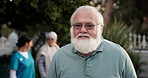Glasses, face and happy with old man in nursing home for occupational therapy, help and healthcare. Medical, retirement and elderly care with person in garden for wellness and assisted living