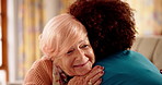 Senior, happy woman and hug with nurse for healthcare, assisted living or support on sofa. Female person, caregiver and embrace with patient for elderly care, old age or help in retirement home