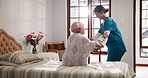 Home, nurse and old woman with help, bedroom and recovery with retirement, smile and healthcare. Pensioner, elderly person and caregiver in uniform, support or rehabilitation with wellness or healing