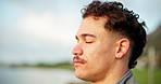 Fitness, breathe and thinking with man in park for workout, health and exercise training. Relax, break and mindfulness with athlete by lake for awareness, balance and commitment with morning routine