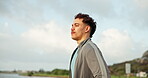 Fitness, breathing and rest with man in park for workout, health and exercise training. Relax, break and mindfulness with athlete by lake for awareness, balance and commitment with morning routine