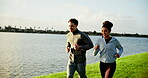 Running, lake or happy couple in park for fitness, wellness or health in relationship for chat. Athletes, talking and people training in nature for outdoor jog, cardio exercise and support in workout