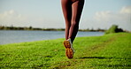 Legs, woman and running for fitness at park for exercise, cardio training and morning routine. Feet, active and person for sports workout, marathon practice and pace challenge for wellness at lake