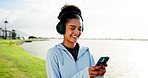 Phone, headphones and woman in nature for fitness, exercise and training with music for wellness outdoor. Sports, runner and person with smartphone, audio and streaming for workout, rest and health