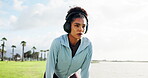 Breathe, runner and woman with headphones in park for running, marathon training and exercise. Sports, outdoor and person with music rest for fatigue, tired and break for workout, fitness and race