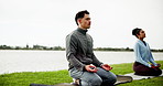 Calm, people and nature with meditation on grass field for inner peace, zen or spiritual connection. Man, woman and relax with yoga or mantra for awareness, chakra or mudra together on ocean coast