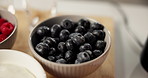 Food, diet and blueberry in bowl for health, nutrition and wellness in home kitchen. Fresh breakfast, natural fruits and closeup with organic meal for vegan benefits, antioxidants and sweet dessert