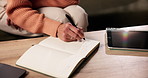 Hand, notebook and writing with person in living room of home for planning or reminder of tasks. Diary, tablet and to do list with senior woman in apartment for agenda, checklist or event schedule