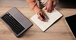 Hand, laptop and notebook with person in living room of home for planning or reminder of tasks. Computer, journal and writing with senior woman in apartment for agenda, checklist or event schedule