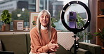 Ring light, phone and woman with live streaming on sofa for social media vlog, interaction or tips. Influencer, mature person and speaking to followers on video for content creation or advice in home