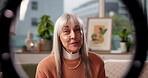 Ring light, face and woman with live streaming in home for social media vlog, networking and tips. Influencer, mature person and speaking to followers on video for content creation and advice on sofa