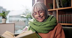 Reading, retirement and wellness with senior woman on sofa in living room of home for hobby. Book, literature or storytelling with smile of happy old person in apartment for knowledge or learning
